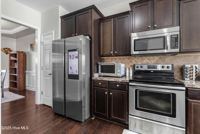 kitchen featuring dark hardwood / wood-style flooring, dark brown cabinetry, and stainless steel appliances