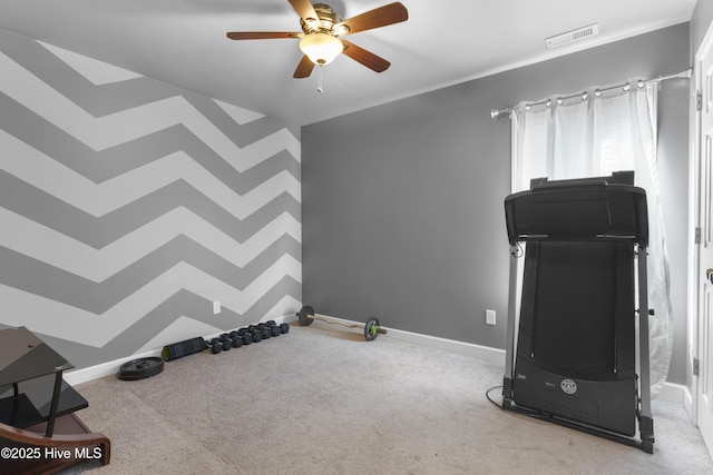 workout area featuring ceiling fan and light colored carpet