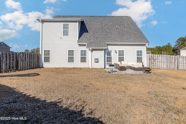 back of house with an outdoor living space with a fire pit, a patio area, and a lawn