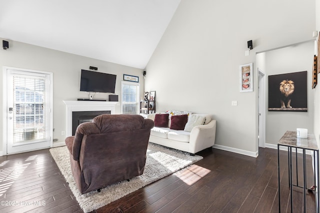 living room with high vaulted ceiling and dark wood-type flooring