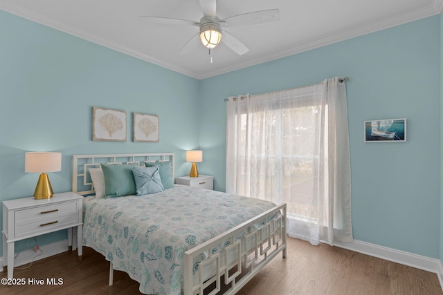 bedroom featuring hardwood / wood-style flooring, ornamental molding, and ceiling fan