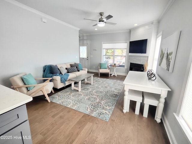 living room featuring crown molding, ceiling fan, and hardwood / wood-style floors