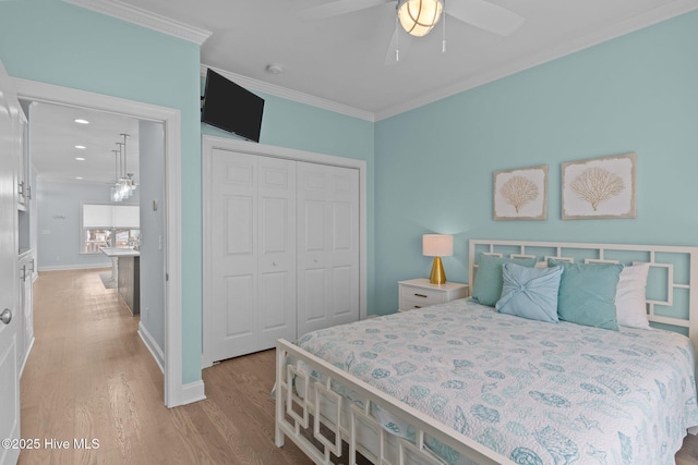 bedroom with crown molding, a closet, ceiling fan, and light wood-type flooring