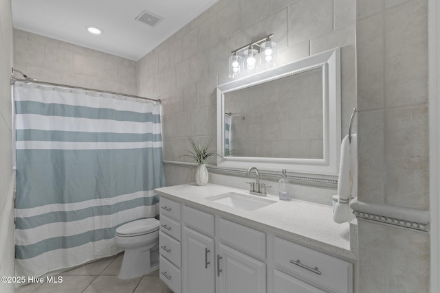 bathroom with tile patterned floors, toilet, tile walls, vanity, and a shower with shower curtain