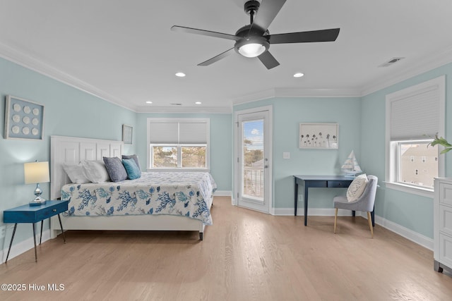 bedroom featuring multiple windows, crown molding, and light hardwood / wood-style floors