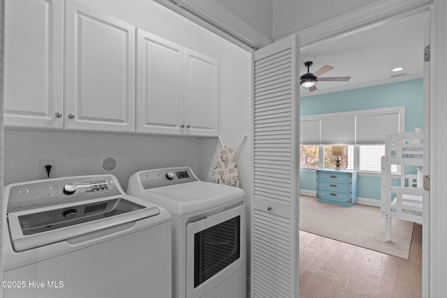 washroom featuring cabinets, ceiling fan, crown molding, washer and clothes dryer, and light hardwood / wood-style flooring