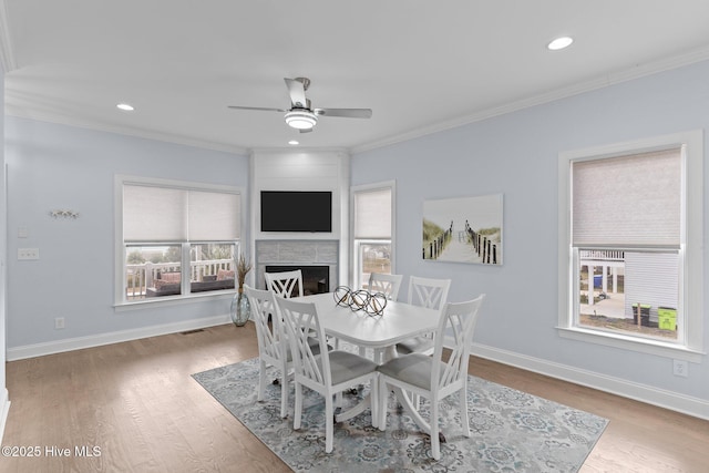 dining area featuring crown molding, ceiling fan, and hardwood / wood-style flooring