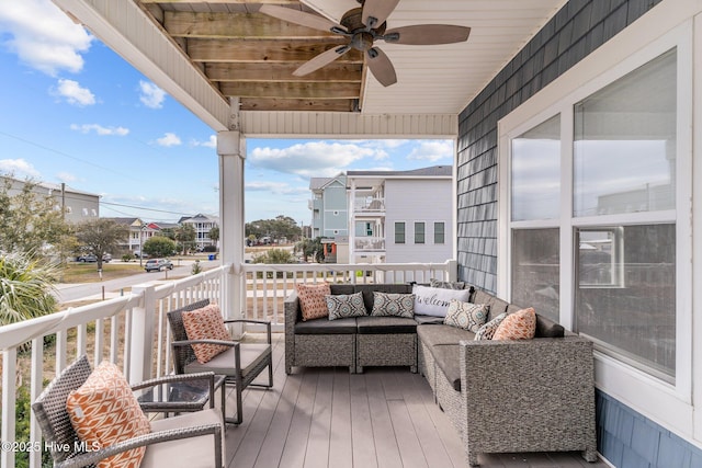 wooden terrace featuring an outdoor hangout area and ceiling fan