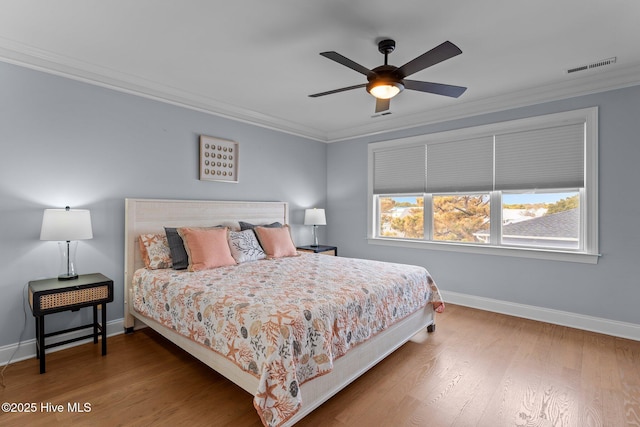 bedroom featuring crown molding, ceiling fan, and dark wood-type flooring