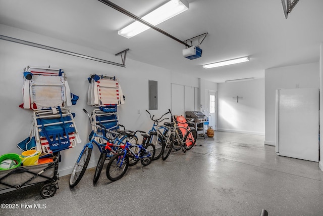 garage with a garage door opener, electric panel, and white refrigerator