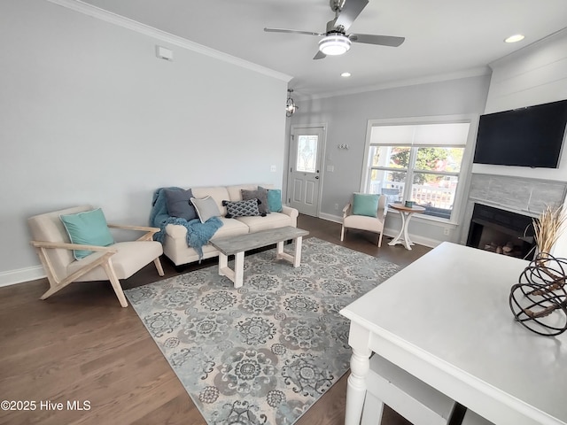 living room featuring dark wood-type flooring, ceiling fan, and ornamental molding