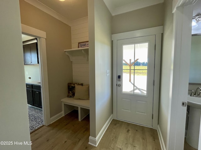 mudroom with light hardwood / wood-style flooring and ornamental molding