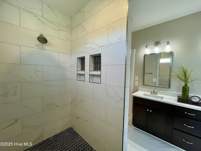 bathroom with vanity and a tile shower