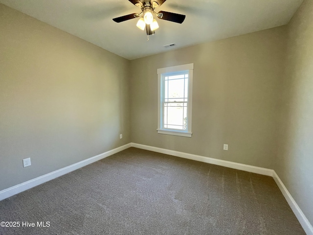 carpeted spare room with ceiling fan