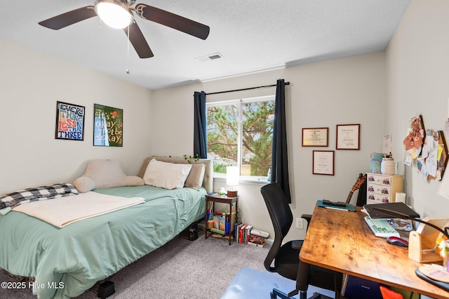 bedroom with ceiling fan, carpet, and a textured ceiling