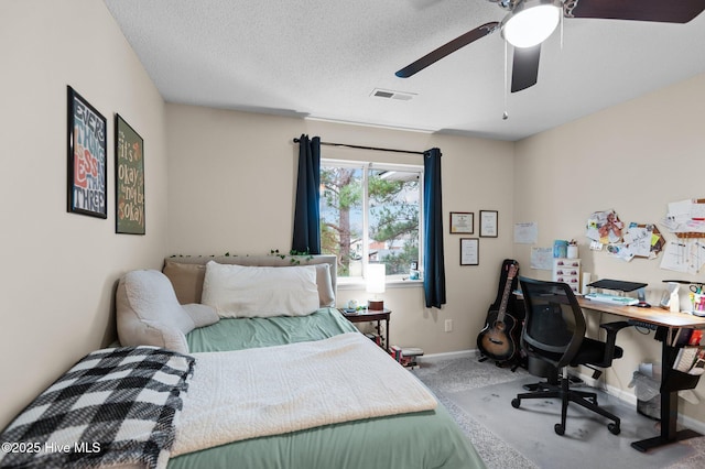 carpeted bedroom with ceiling fan and a textured ceiling