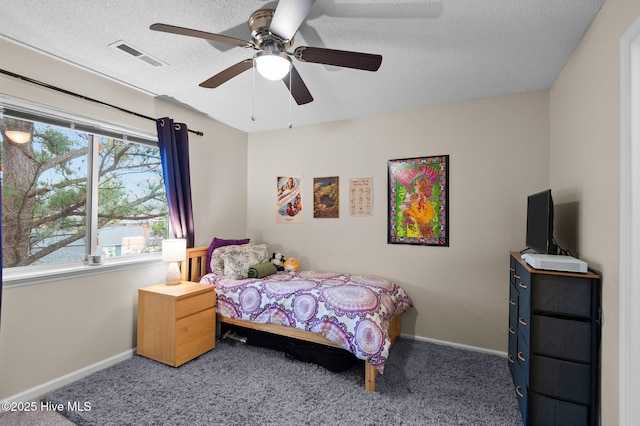 bedroom with multiple windows, ceiling fan, and carpet