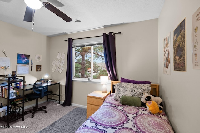 carpeted bedroom with a textured ceiling and ceiling fan