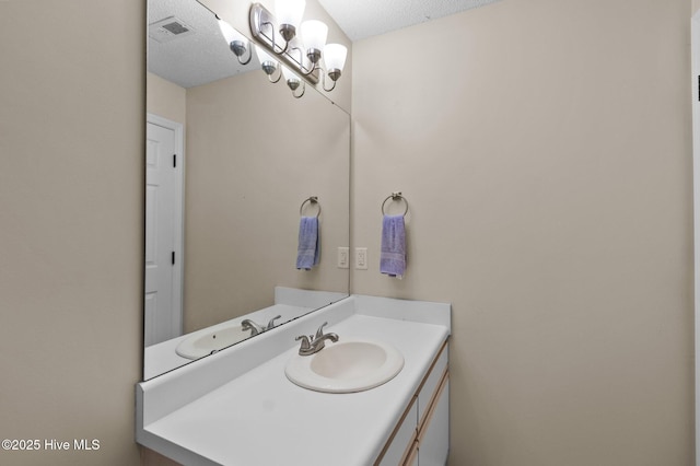 bathroom with vanity and a textured ceiling