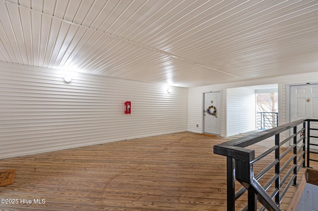 interior space with wood walls and wood-type flooring