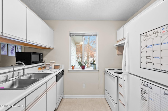 kitchen featuring white cabinets, a textured ceiling, white appliances, and sink