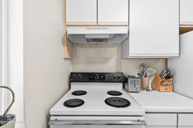 kitchen featuring white cabinets and electric stove