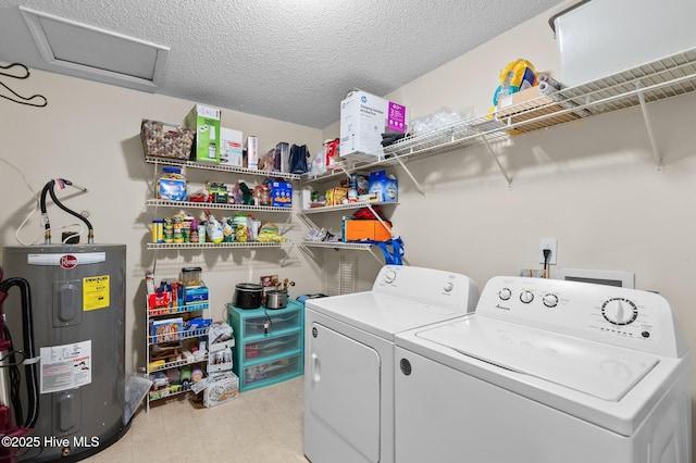 clothes washing area featuring a textured ceiling, electric water heater, and separate washer and dryer