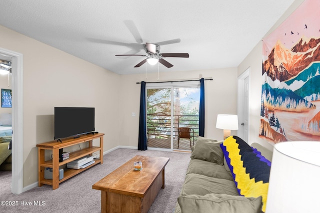 living room with ceiling fan, light colored carpet, and a textured ceiling