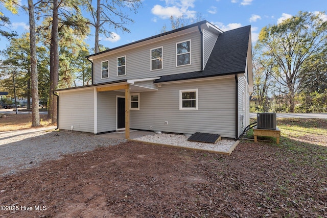 rear view of house with central AC unit