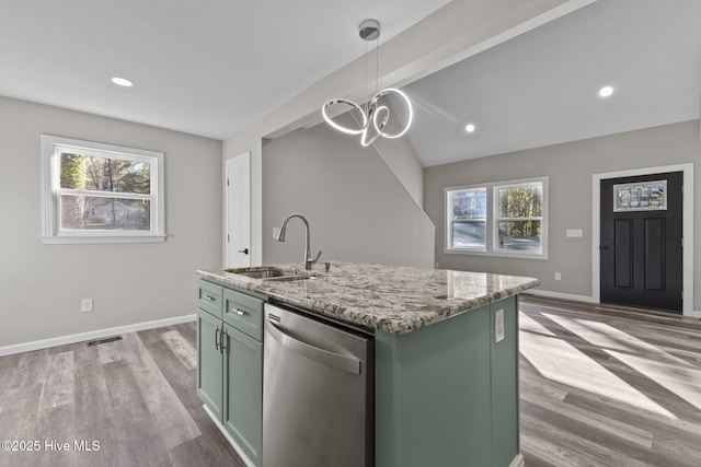 kitchen featuring a wealth of natural light, sink, a center island with sink, dishwasher, and hanging light fixtures