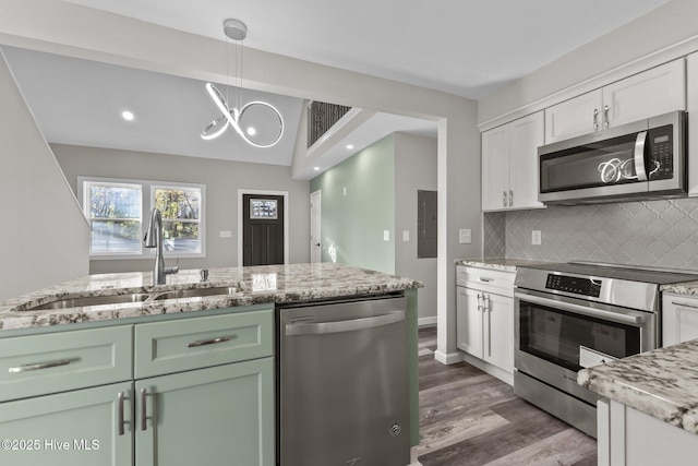 kitchen featuring tasteful backsplash, stainless steel appliances, sink, white cabinets, and green cabinets