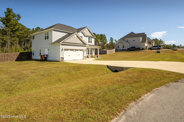 view of front of property with a front yard, central AC, a garage, and covered porch