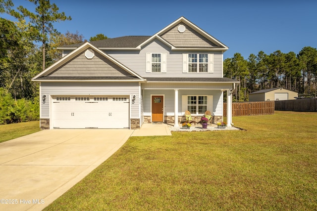 craftsman-style home featuring covered porch, a garage, and a front lawn