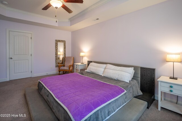 carpeted bedroom featuring a tray ceiling, ceiling fan, and ornamental molding