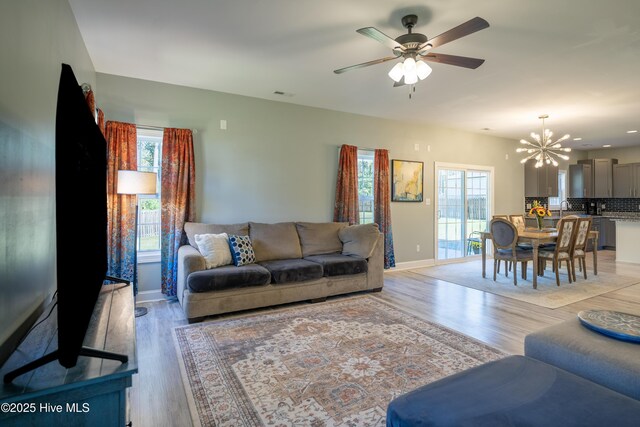 living room with hardwood / wood-style flooring and ceiling fan