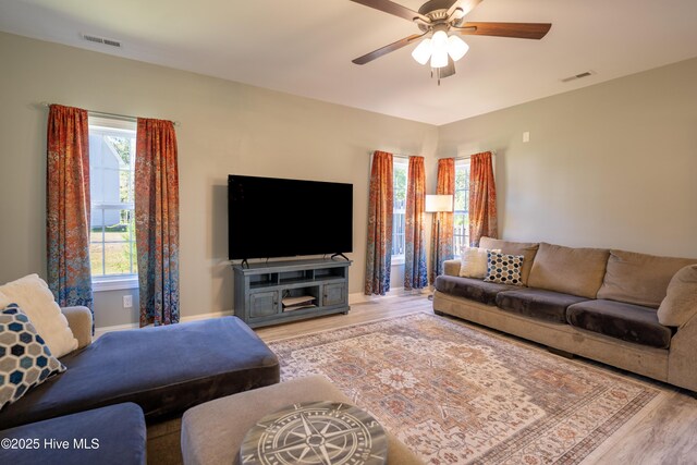 living room with hardwood / wood-style floors and ceiling fan