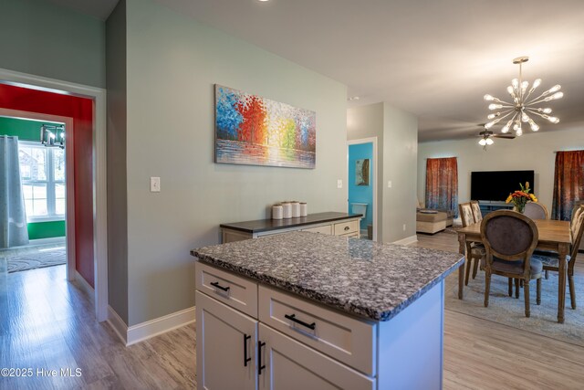 kitchen with sink, stainless steel appliances, gray cabinetry, and wall chimney range hood