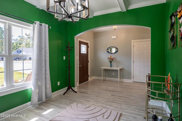 miscellaneous room with ornamental molding, coffered ceiling, light hardwood / wood-style flooring, beamed ceiling, and a chandelier