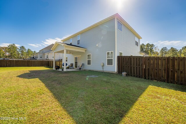 rear view of house with a patio area and a yard