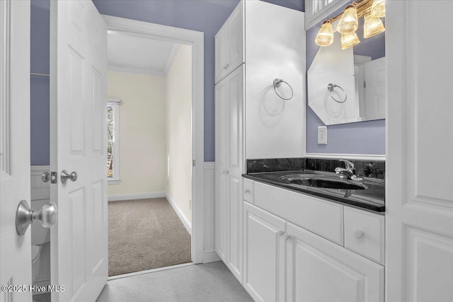 bathroom featuring crown molding and vanity