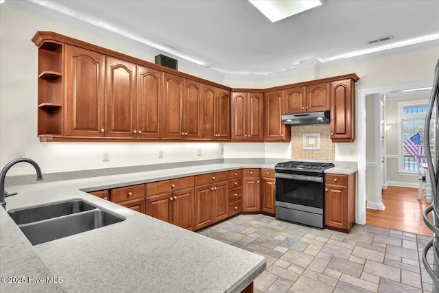 kitchen featuring decorative backsplash, sink, black range, and ornamental molding