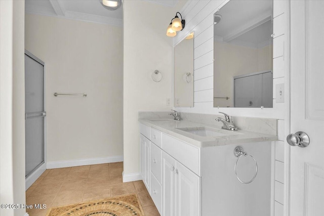 bathroom with tile patterned flooring, vanity, and crown molding