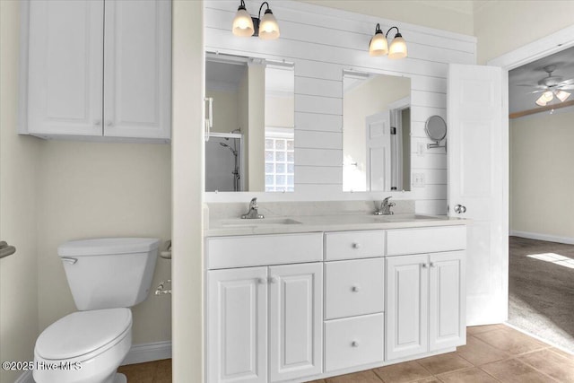 bathroom featuring toilet, vanity, tile patterned floors, and ceiling fan