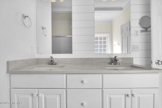 bathroom with vanity and ornamental molding