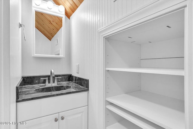 bathroom featuring vanity, lofted ceiling, and wood ceiling