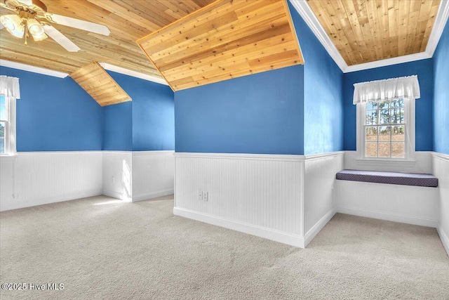 empty room featuring lofted ceiling, light colored carpet, ceiling fan, and wooden ceiling