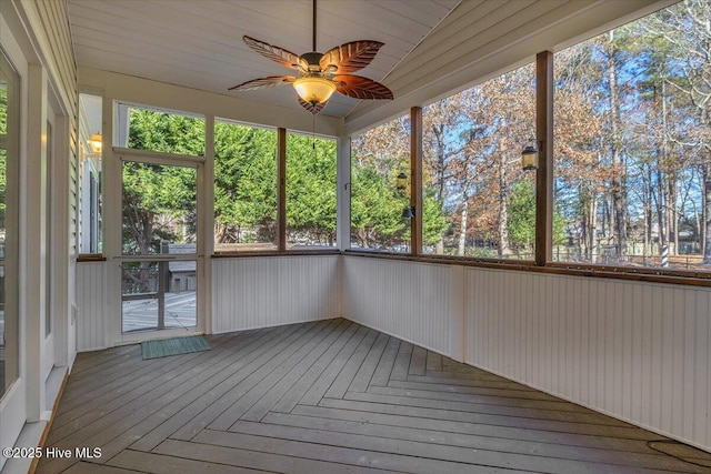 unfurnished sunroom featuring ceiling fan