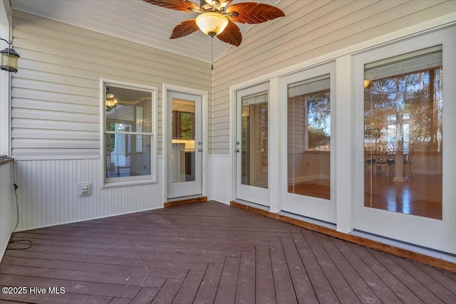 unfurnished sunroom with ceiling fan