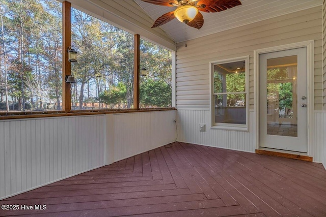 unfurnished sunroom featuring ceiling fan