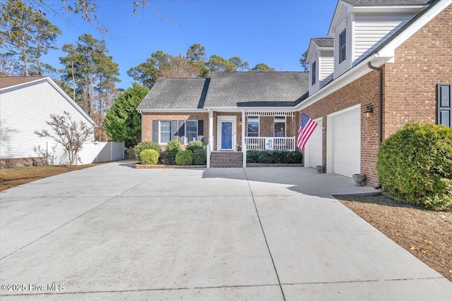 cape cod house featuring a porch and a garage